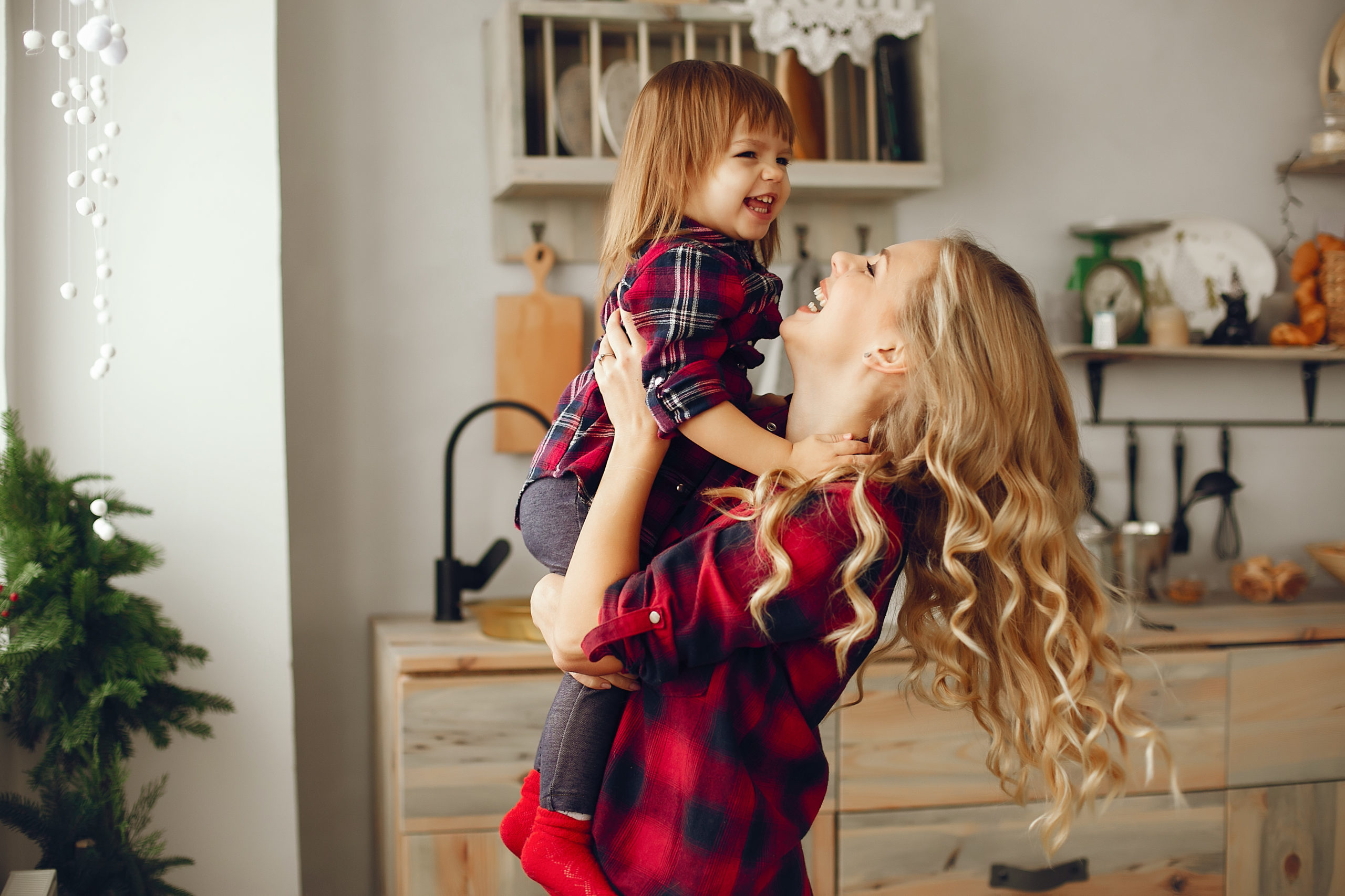 Mother with little daughter in a kitchen