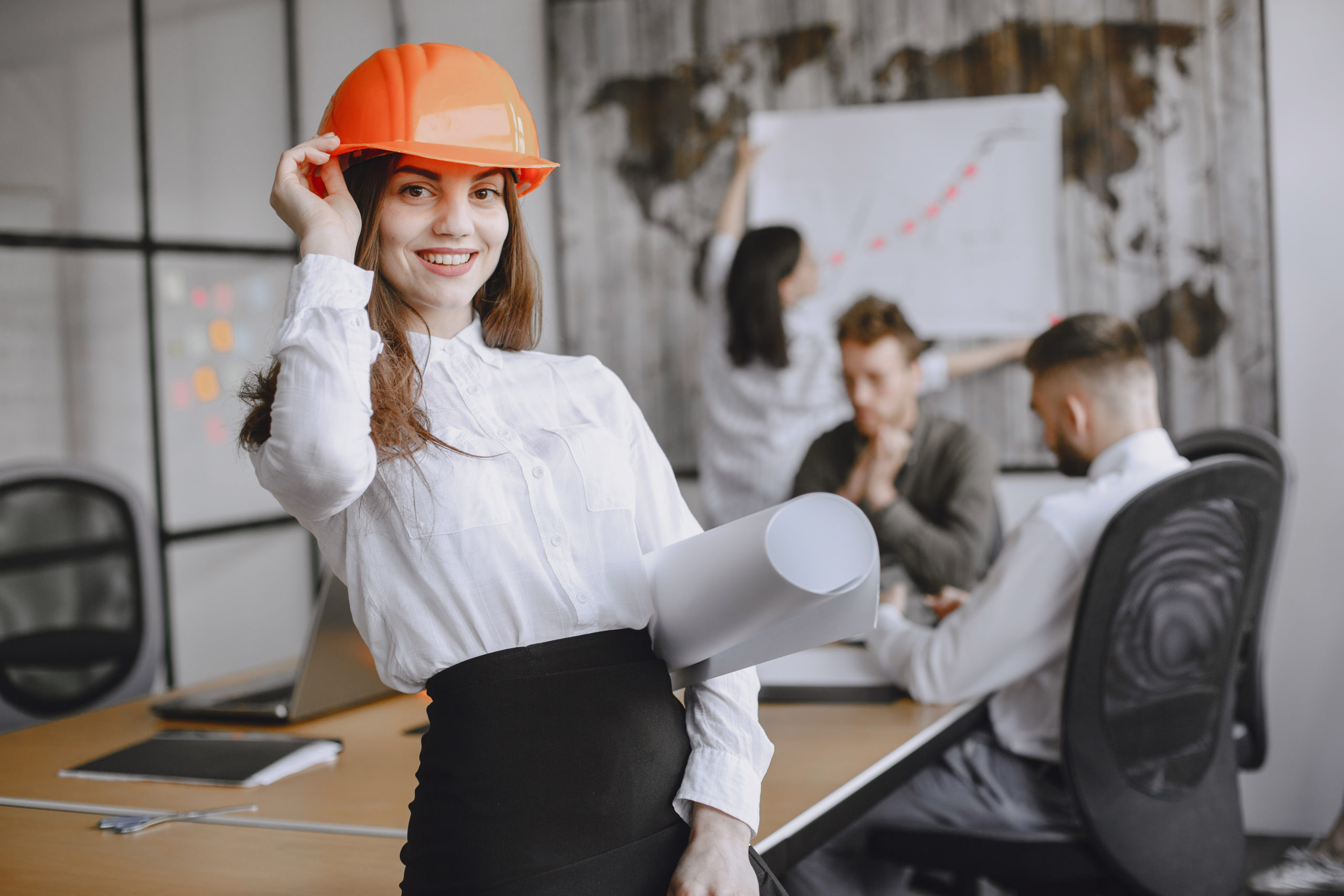 Woman holding blueprints in her hands.